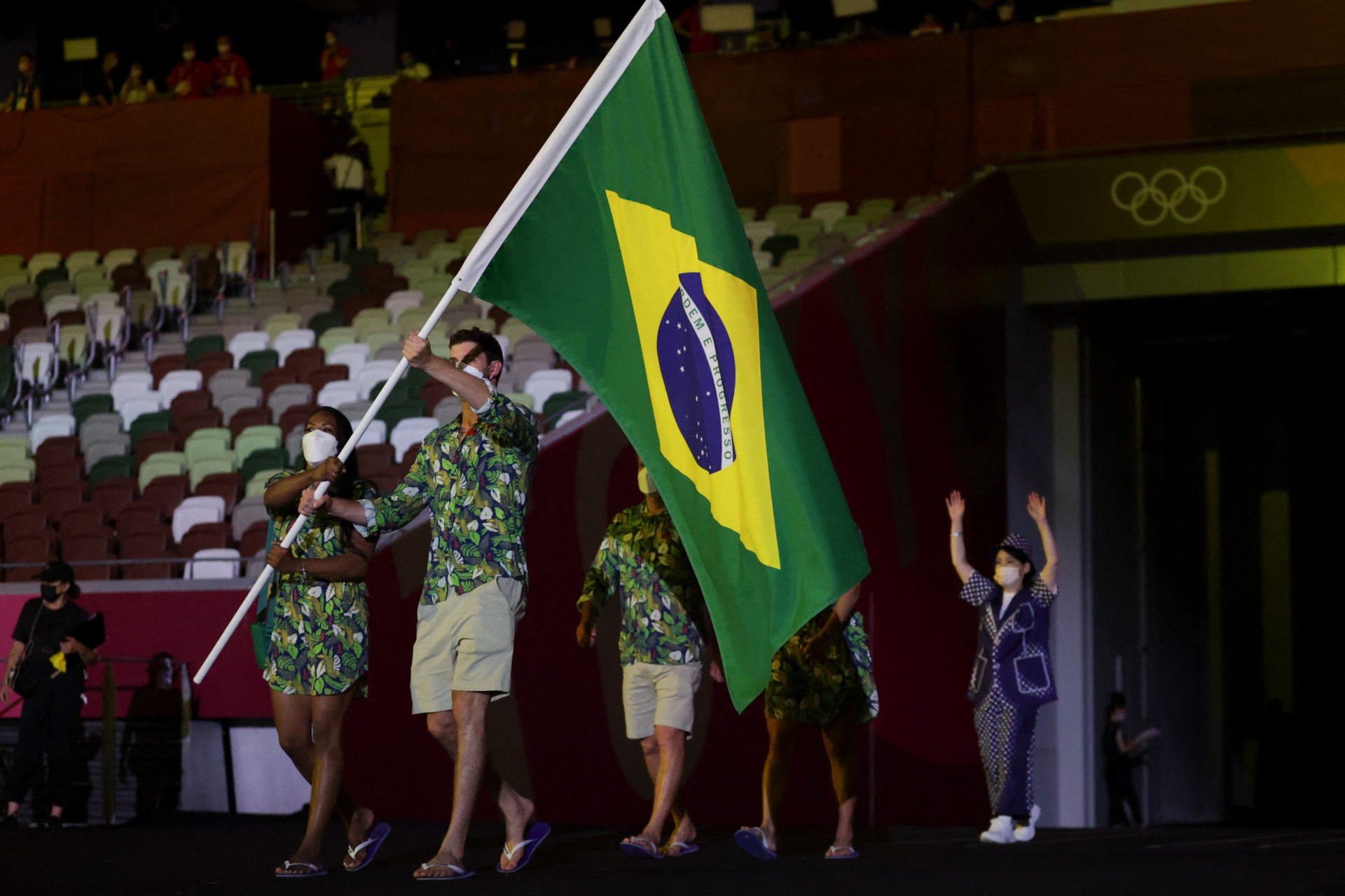 Brazil's flag bearers Ketleyn Quadros (L) and Bruno Mossa Rezende lead the delegation during the Tokyo 2020 Olympic Games opening ceremony's parade of athletes, at the Olympic Stadium in Tokyo on July 23, 2021. (Photo by HANNAH MCKAY / POOL / AFP) - AFP