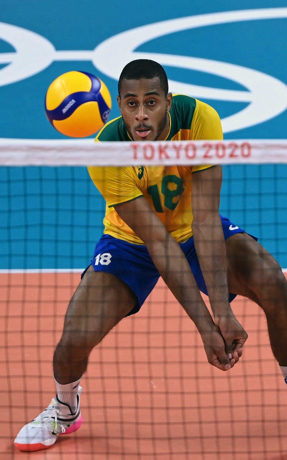 Brazil's Ricardo Souza hits the ball in the men's quarter-final volleyball match between Japan and Brazil during the Tokyo 2020 Olympic Games at Ariake Arena in Tokyo on August 3, 2021. (Photo by YURI CORTEZ / AFP) - AFP