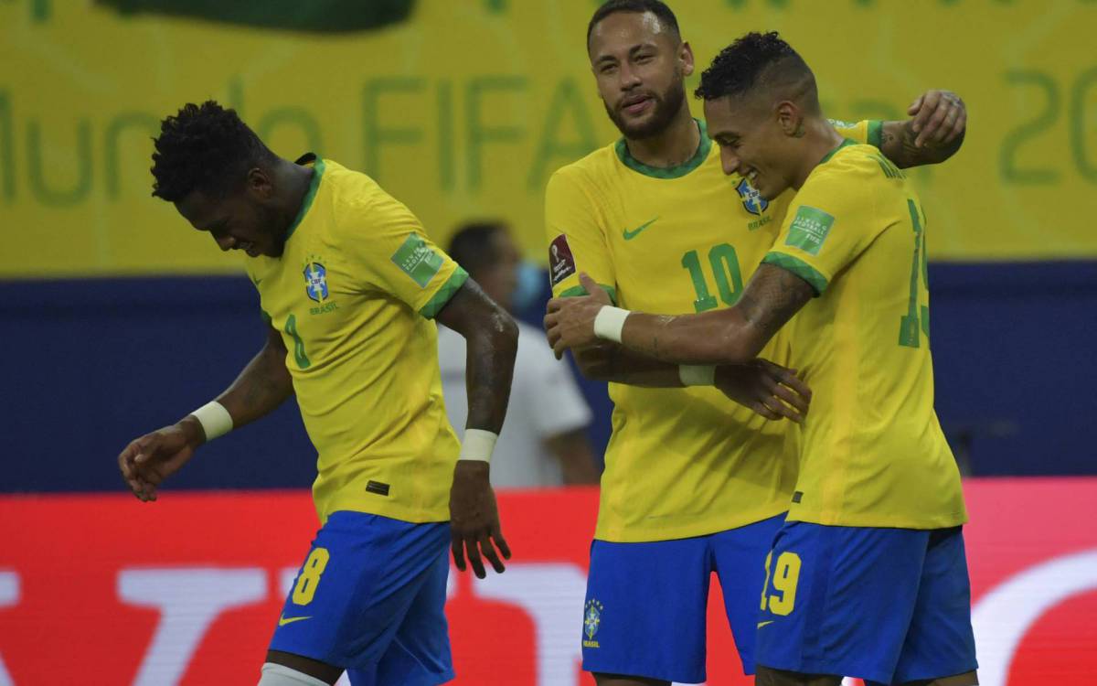 Brazil's Raphinha (R) celebrates with Brazil's Neymar after scoring against Uruguay during the South American qualification football match for the FIFA World Cup Qatar 2022, in Arena Amazonia, Manaus, Brazil, on October 14, 2021. (Photo by NELSON ALMEIDA / AFP)