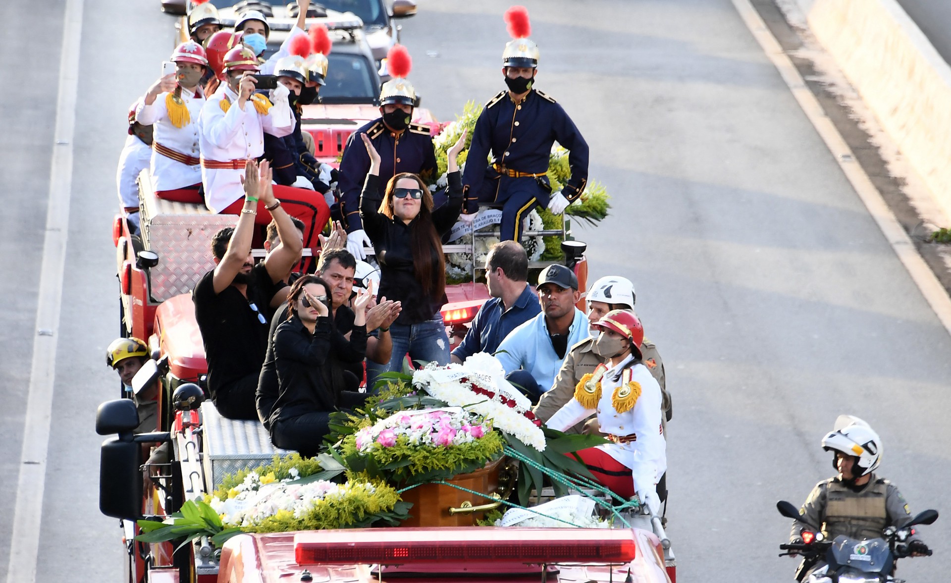 A military firefighter brigade truck carrying the remains of Brazilian singer Marilia Mendonca drives along the GO-020 highway to the Cementerio Parque Memorial, in Goiania, state of Goias, Brazil, on November 6, 2021. - Marilia Mendonca, 26, one of the most popular of the 