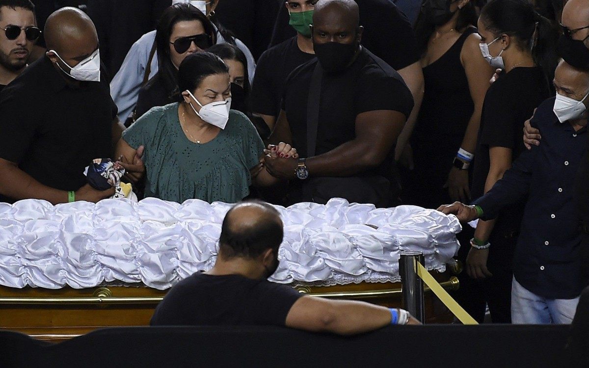 Ruth Moreira Dias (C), the mother of Brazilian singer Marilia Mendonca, mourns next to her coffin during her wake at the Arena Goiania sports centre, in Goiania, state of Goias, Brazil, on November 6, 2021. - Marilia Mendonca, 26, one of the most popular of the 