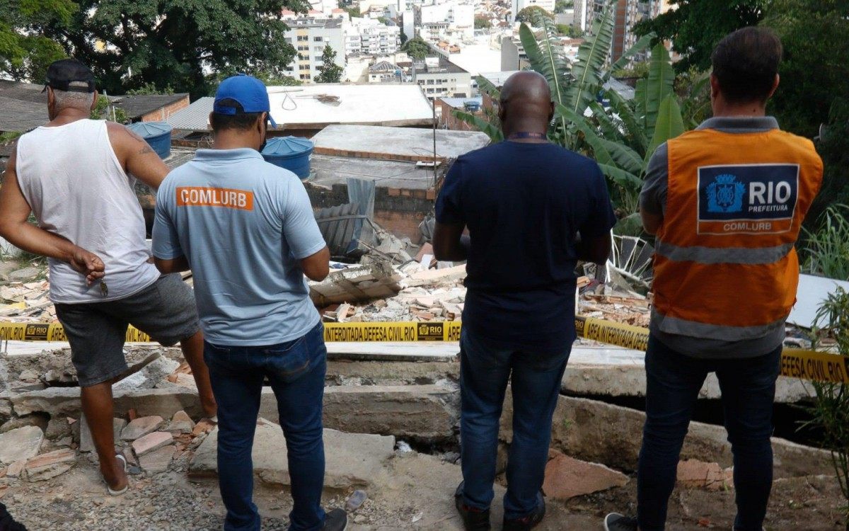 Técnicos da Secretaria Conservação e funcionários da Comlurb fazem a limpeza do terreno no Morro do Salgueiro, onde um imóvel de três andares caiu, na noite de quarta (17). Um homem morreu