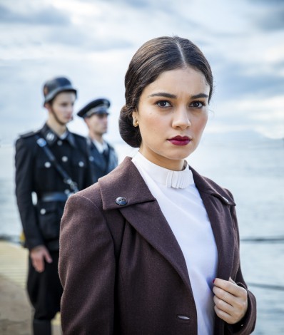 Angel of Hamburg
O Anjo de Hamburgo 
EPK
Item 3 - Cap 1 - Cena 6A – Vivi ( Gabriela Petry ) é atacada por jovens. Zumkle ( Peter Ketnath ) a salva. Repreende Hans ( Nicolas Ahnert ). Fotos: Essa cena é muito importante. Zumkle é o nosso antagonista, capitão da tropa nazista. Ele tem um romance secreto com Vivi, que é judia. Precisamos de fotos de cena que tenham o ar desse “relacionamento secreto” entre os dois.  Angel of Hamburg
O Anjo de Hamburgo 
EPK
 Item 4 - Cap 2 - Cena 57 – Aracy ( Sophie Charlotte ) vê indignada judeus de todas as idades sendo expulsos de suas casas. Fotos: Precisamos de fotos que traduzam o clima tenso do momento. Judeus sendo expulsos. Se os judeus estiverem com as estrelas amarelas, capturar isso também. 
  - Divulgação/Globo