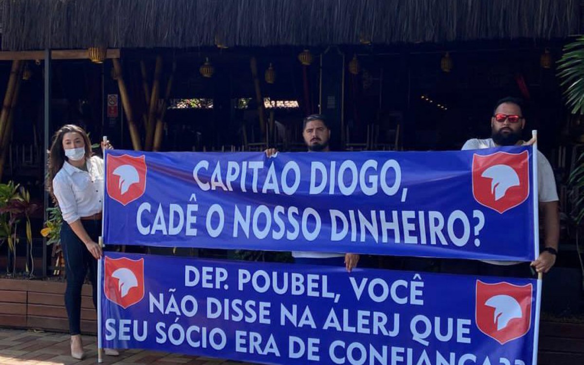 Em uma das faixas usadas no protesto, v&iacute;timas do calote cobram um posicionamento do deputado bolsonarista, Felippe Poubel que &eacute; s&oacute;cio de Capit&atilde;o Diogo  