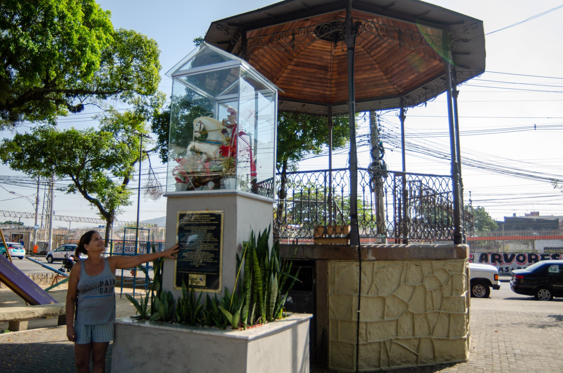 M&aacute;rcia Curcino, moradora h&aacute; 29 anos de Quintino, zona norte do Rio de Janeiro, exibe a imagem de S&atilde;o Jorge, recentemente posta junto ao coreto, onde se realizam missas do santo - Vanessa Ataliba/Ag&ecirc;ncia O Dia