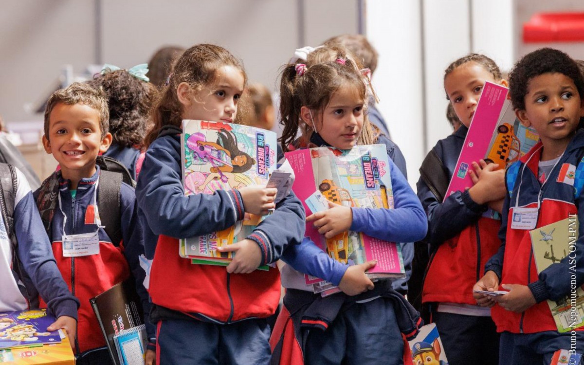 Emocionadas, crian&ccedil;as seguram os livros comprados com o voucher entregue na Feira L&ecirc; Ter&ecirc;