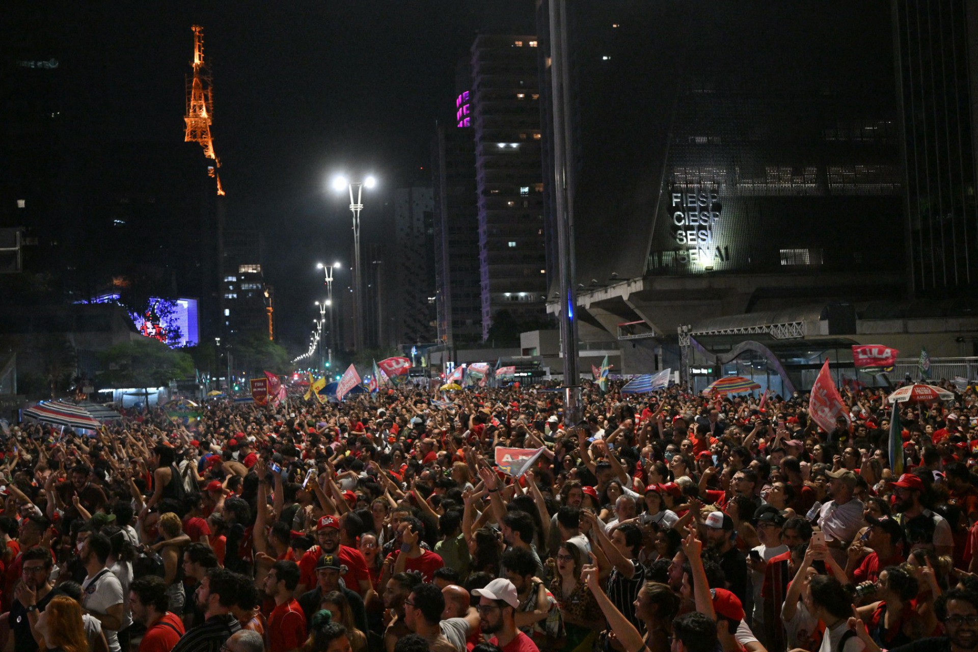 Supporters of Brazilian elected president for the leftist Workers Party (PT) Luiz Inacio Lula da Silva celebrate after their candidate won the presidential runoff election at the Paulista avenue in Sao Paulo, Brazil, on October 30, 2022. Brazil's veteran leftist Luiz Inacio Lula da Silva was elected president Sunday by a hair's breadth, beating his far-right rival in a down-to-the-wire poll that split the country in two, election officials said.
NELSON ALMEIDA / AFP - AFP