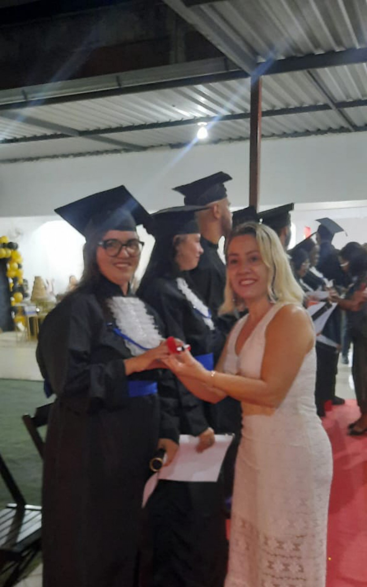 A aluna Bruna Teixeira foi a primeira a receber o certificado da EJA das mãos da orientadora pedagógica Rosemeire Monteiro