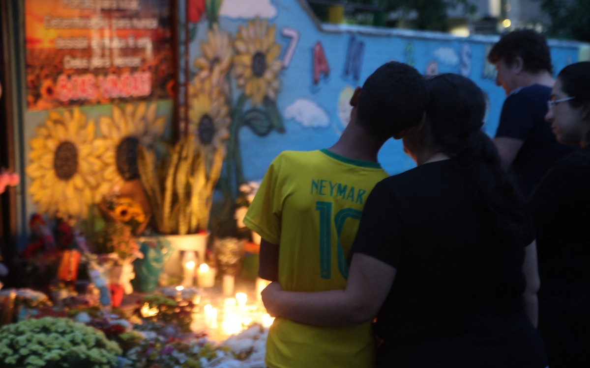 People take part in a vigil outside the Good Shepherd Center private preschool in Blumenau, Santa Catarina State, in southern Brazil, on April 6, 2023. A 25-year-old attacker burst into the private creche and killed four children with a bladed weapon before turning himself in to police, authorities said. Police and government officials said the man had also wounded four other people.
Anderson Coelho / AFP -  Anderson Coelho / AFP