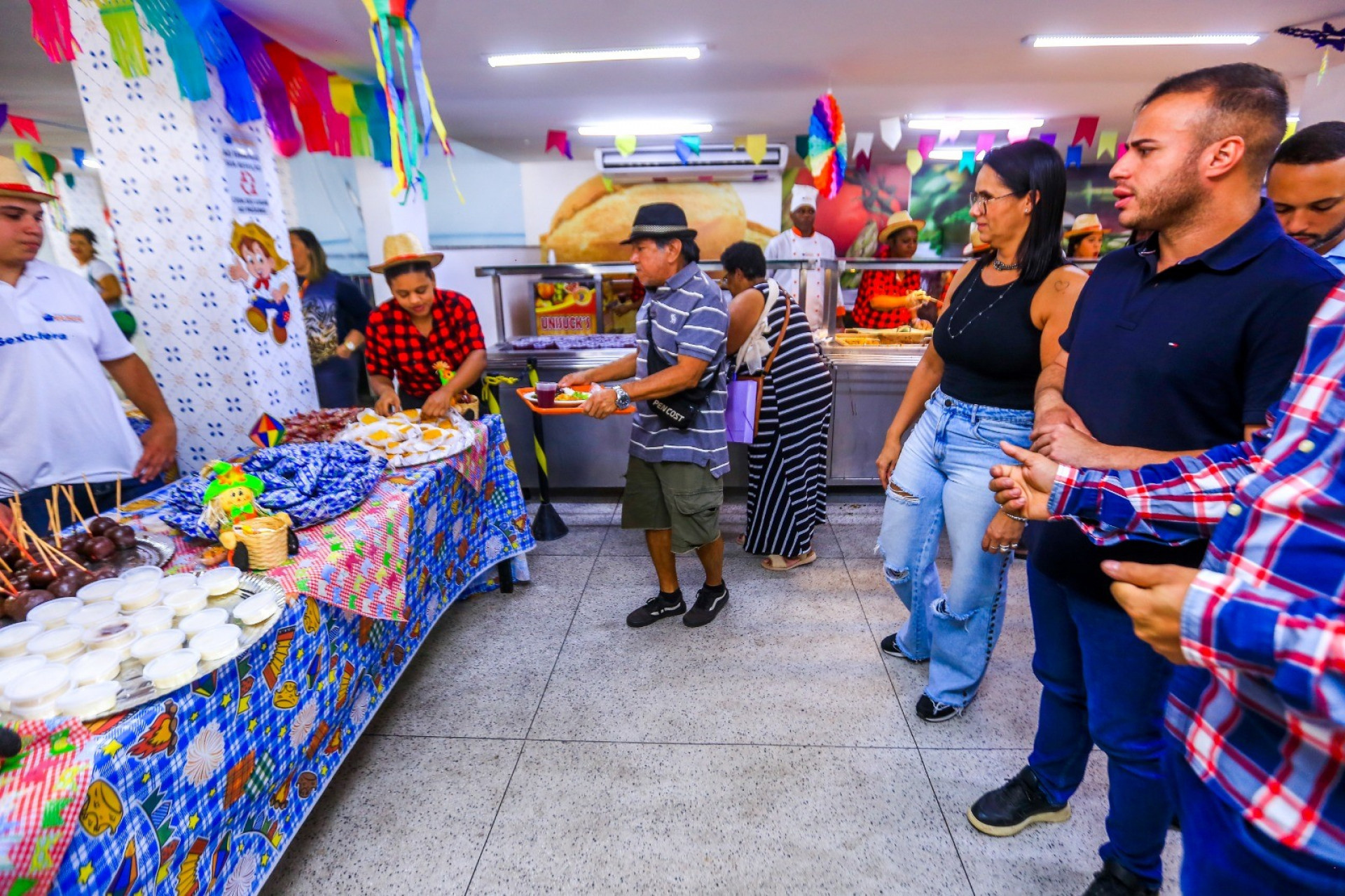 Tati Ervite e Matheus Carneiro observam a mesa montada com tema de festa junina que agradou aos frequentadores - Rafael Barreto / PMBR
