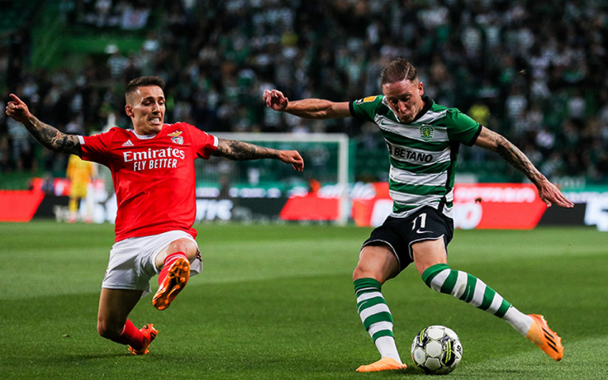 Benfica's Spanish midfielder Alex Grimaldo (L) challenges Sporting's Portuguese forward defender Nuno Santos during the Portuguese league football match between Sporting CP and SL Benfica at the Jose Alvalade stadium in Lisbon on May 21, 2023. (Photo by CARLOS COSTA / AFP) (Photo by CARLOS COSTA/AFP via Getty Images)
