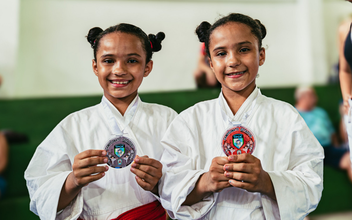 As filhas gêmeas, Laura e Maitê, de 7 anos, seguem os passos do pai e já conseguiram suas próprias medalhas