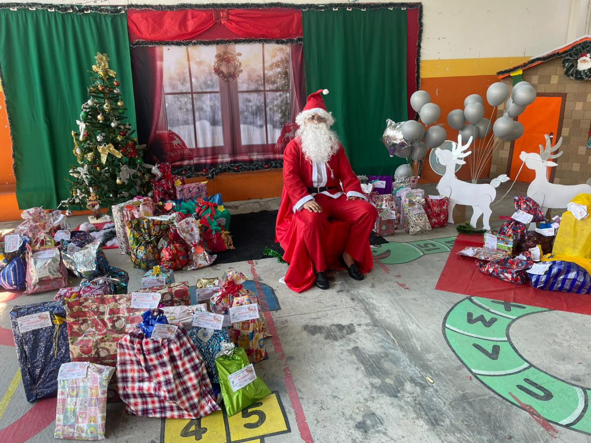 O Papai Noel na sua casa junto com os presentes que foram dado aos alunos - Divulgação