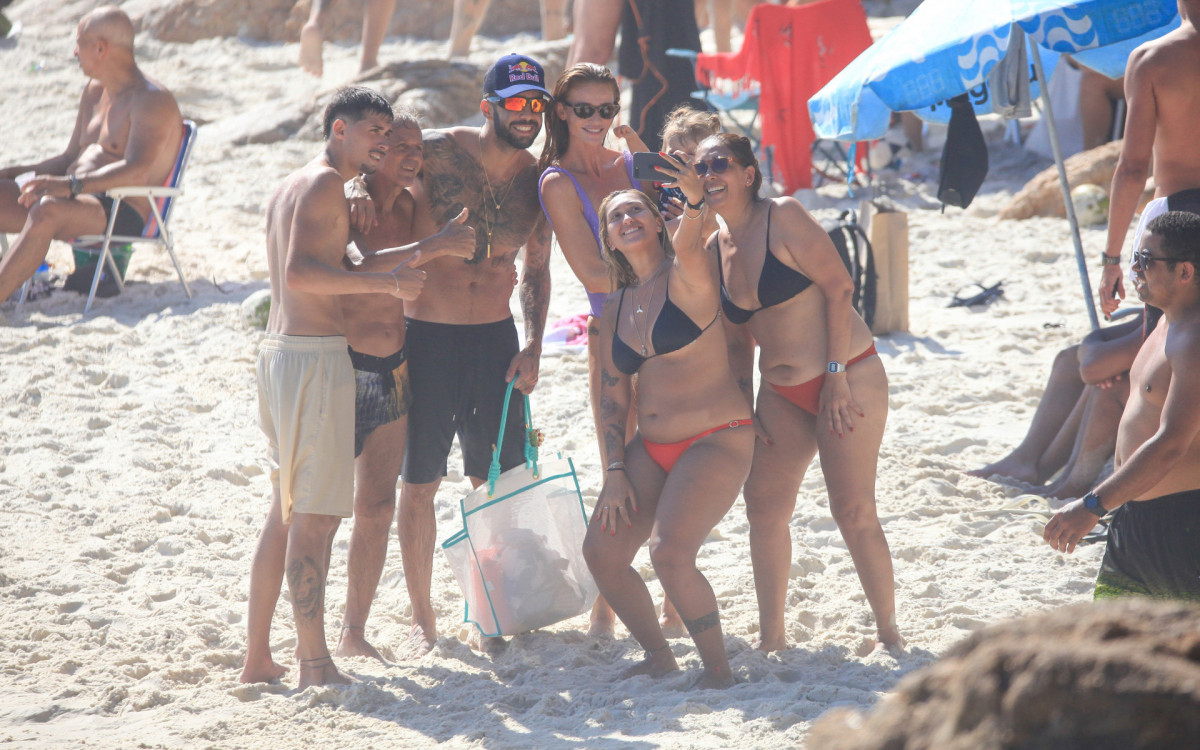 Pedro Scooby, Cintia Dicker e Aurora tiram selfie com banhistas 