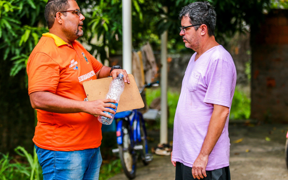 Benedito Meireles ouve atentamente as explicações do agente sobre a proliferação do mosquito da dengue