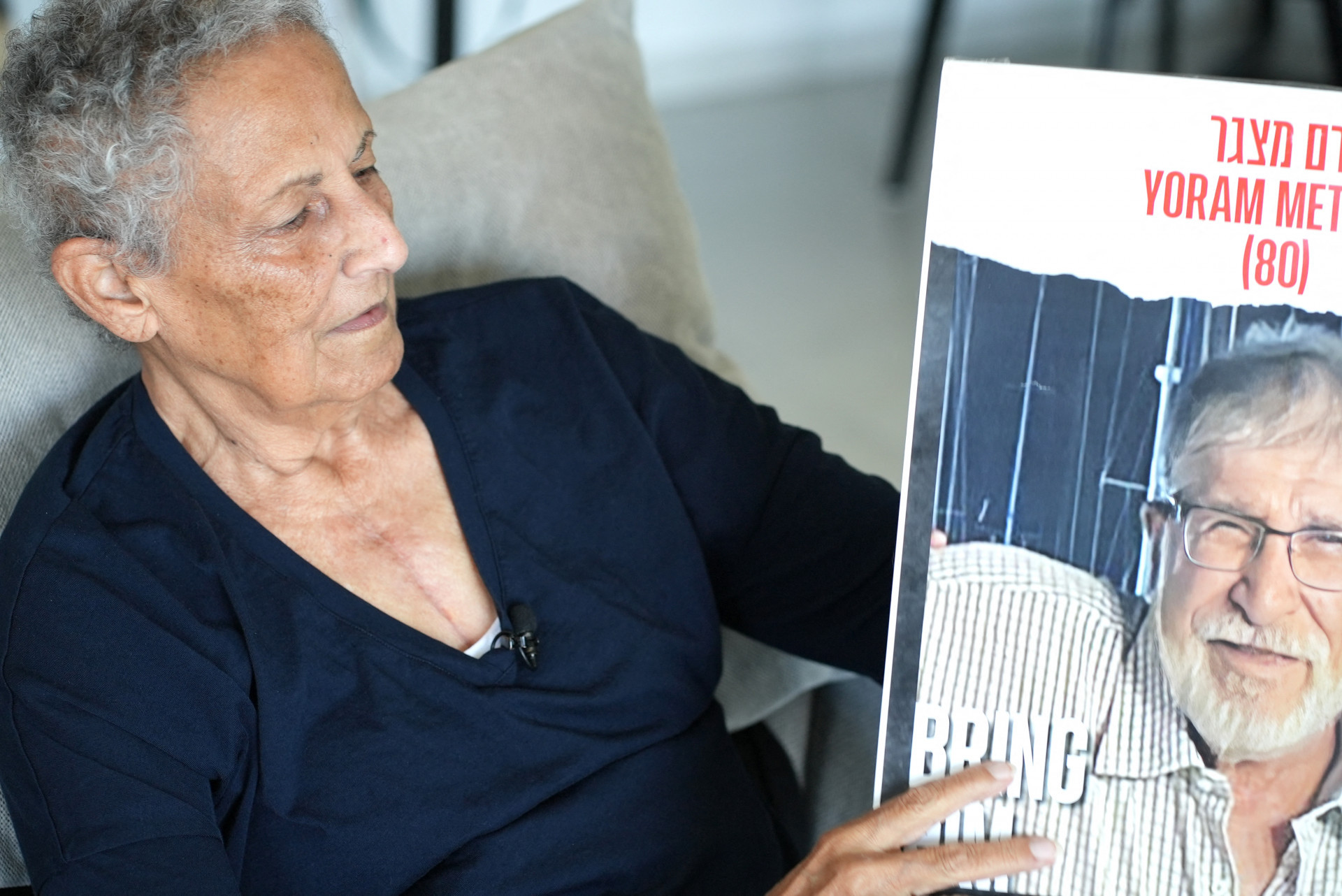 Tami Metzger com o cartaz de desaparecido do marido Yoram  - Sharon Aronwicz / AFP