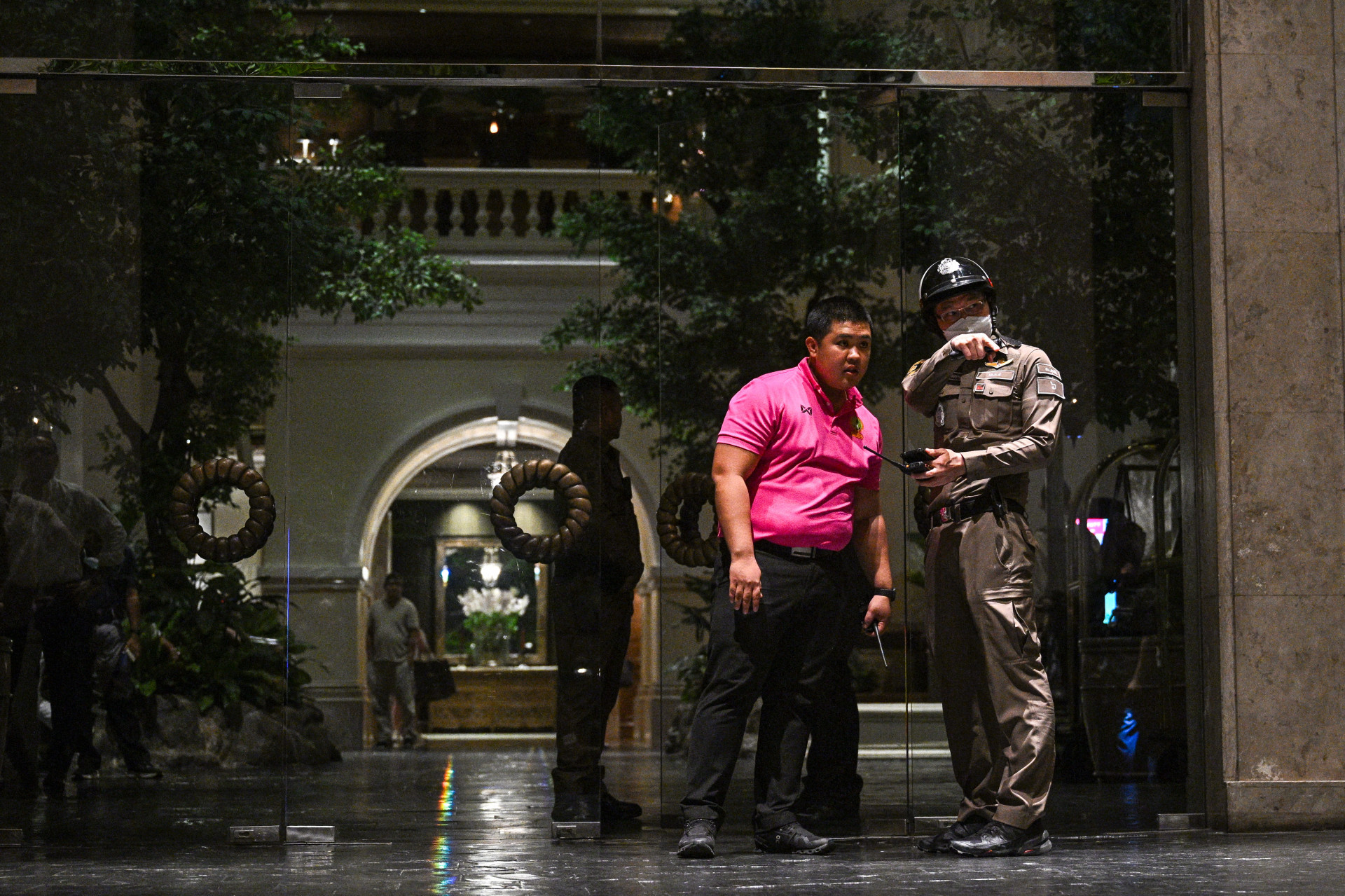 Segurança foi reforçada na entrada do hotel para remoção dos corpos e investigação do local do crime - Lillian Suwanrumpha / AFP