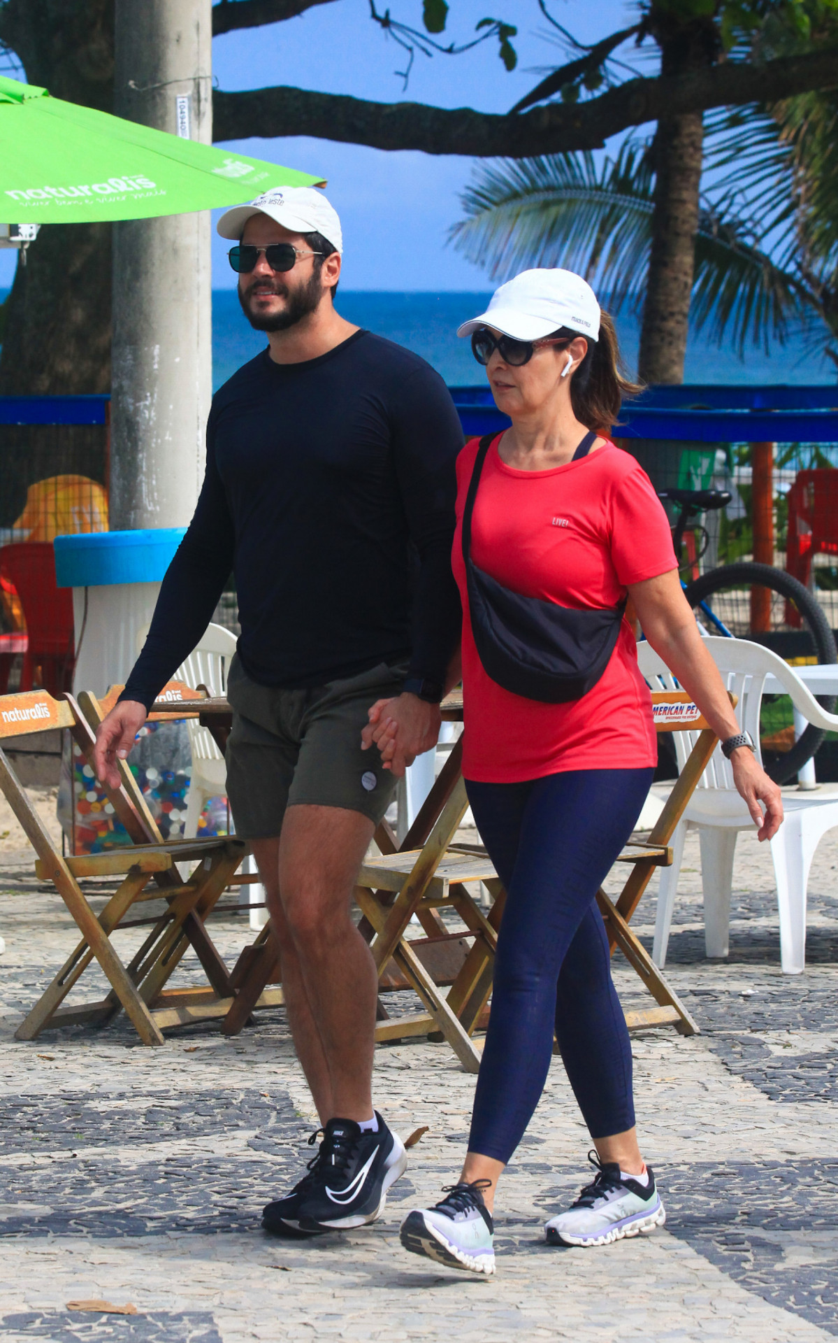 Fátima Bernardes e Túlio Gadêlha caminham na orla da Barra da Tijuca