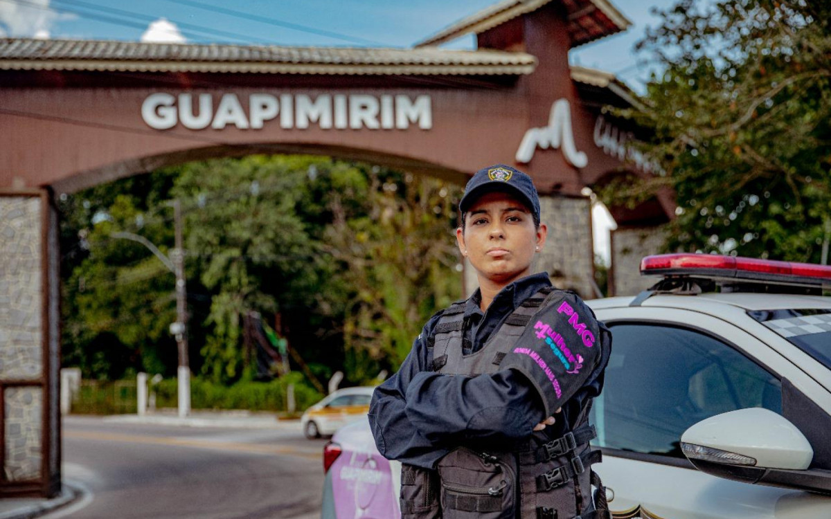 Agente da Guarda Municipal de Guapimirim em frente ao pórtico principal da cidade, com a viatura usada no programa Mulher Mais Segura - Foto: Secom PMG - Imagem cedida ao DIA - Arquivo