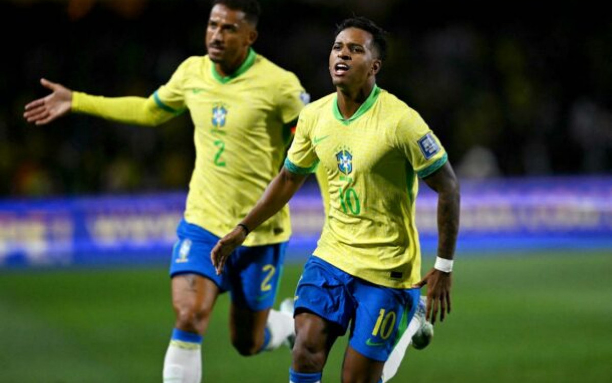 Brazil's forward Rodrygo (R) celebrates with teammate defender Danilo after scoring during the 2026 FIFA World Cup South American qualifiers football match between Brazil and Ecuador, at the Major Antônio Couto Pereira stadium in Curitiba, Brazil, on September 6, 2024. (Photo by Mauro PIMENTEL / AFP) (Photo by MAURO PIMENTEL/AFP via Getty Images)