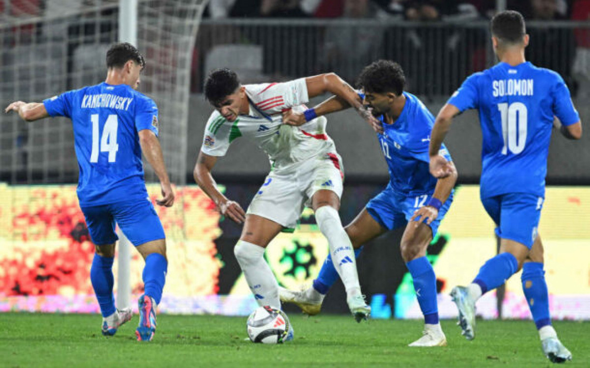 Italy's midfielder #12 Raoul Bellanova and Israel's defender #12 Roy Revivo vie for the ball during the UEFA Nations League, League A, Group A2 football match Israel vs Italy at the Bozsik Arena in Budapest, Hungary, on September 9, 2024. (Photo by Attila KISBENEDEK / AFP)