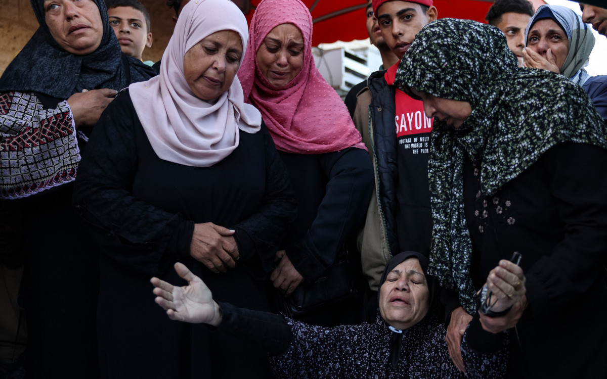 Amigos e familiares se reuniram em volta dos corpos das vítimas do bombardeio - Reprodução / Bashar Taleb / AFP