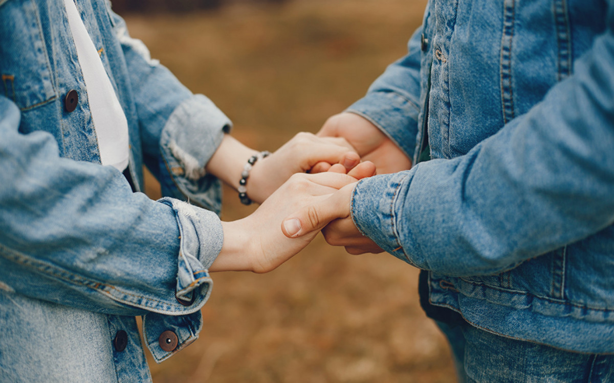 gentle and stylish couple are having a walk in the autumn park