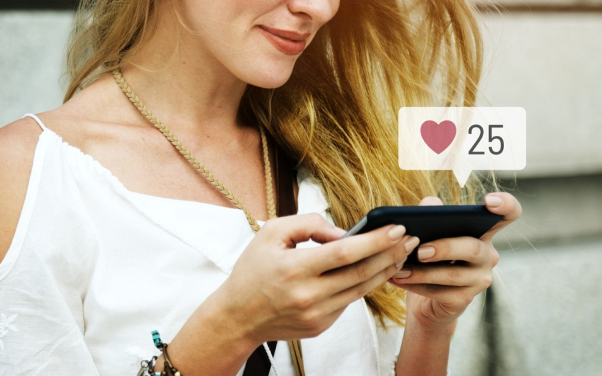 Happy woman using social media on her smartphone