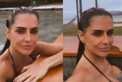 De biquíni, Deborah Secco curte piscina em dia nublado no RJ