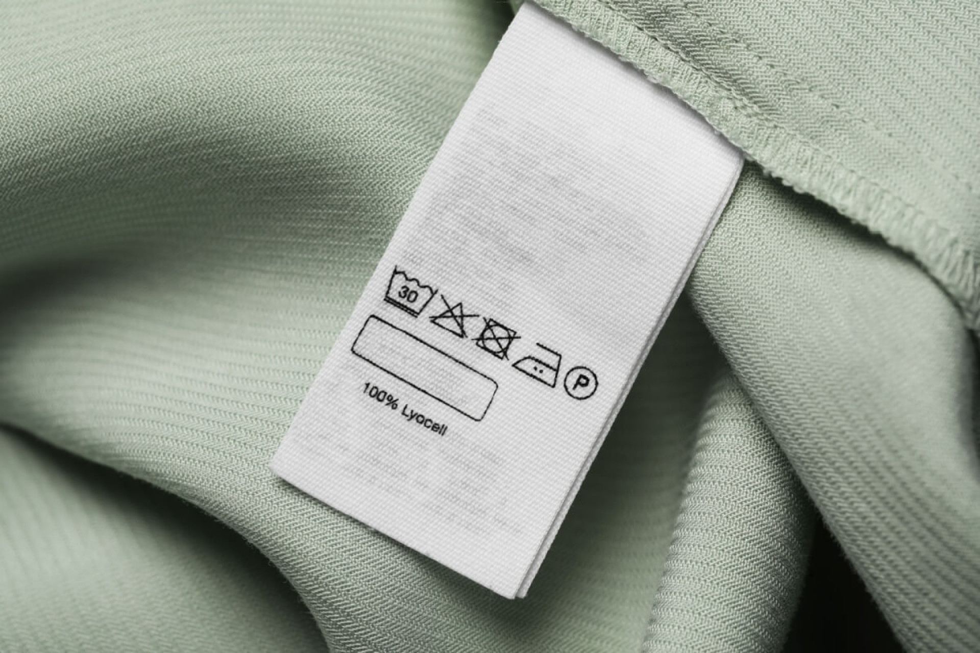 As informa&ccedil;&otilde;es da etiqueta orientam como lavar a pe&ccedil;a corretamente e garantir a durabilidade do tecido (Imagem: New Africa | Shutterstock)