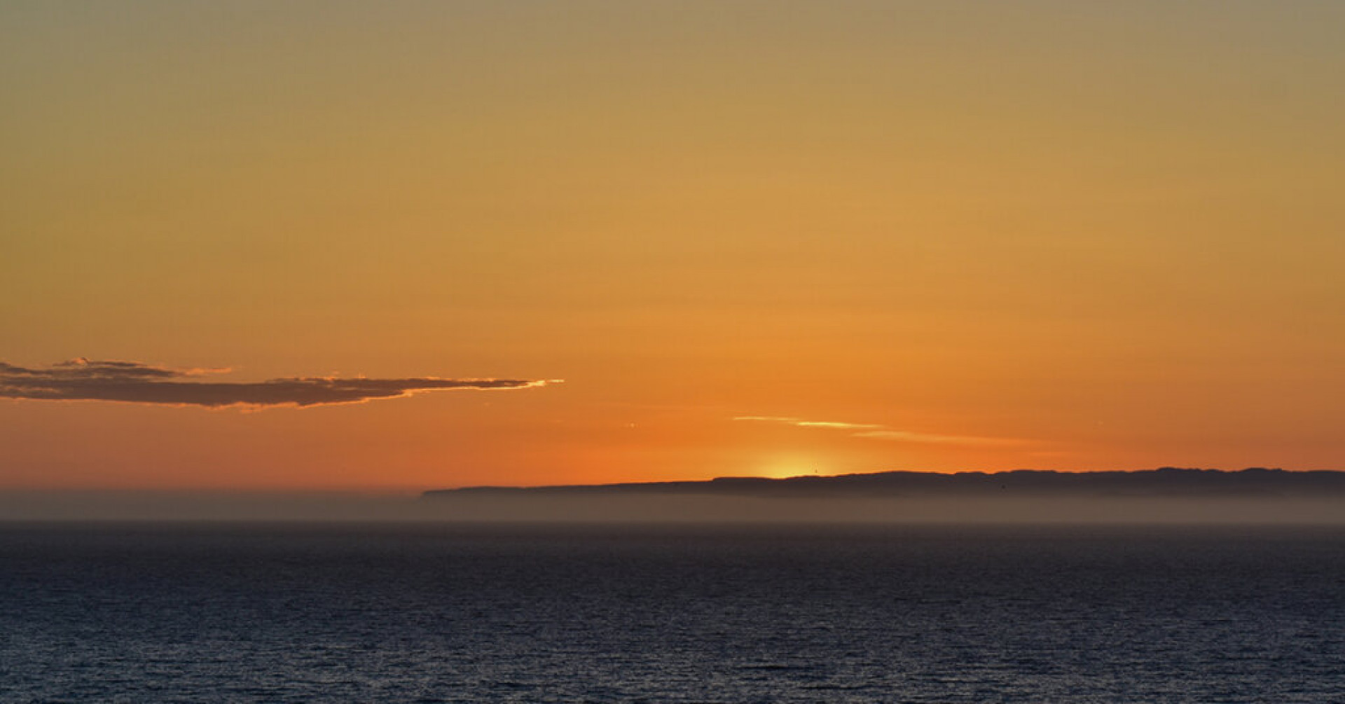 A beautiful scenery of the peaceful sea with the breathtaking sunset in the background