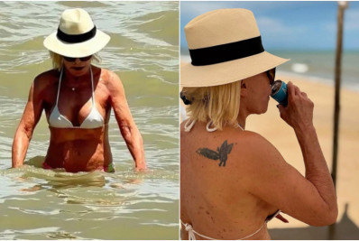 Ana Maria Braga curte praia de biquíni com o marido e exibe tatuagem