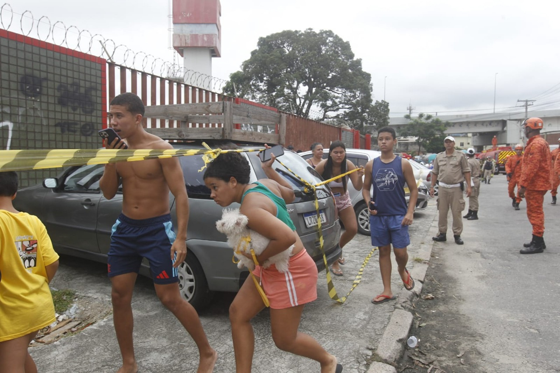 Rhayane Lira corre com sua cachorrinha para se afastar do incêndio - Reginaldo Pimenta/Agência O Dia