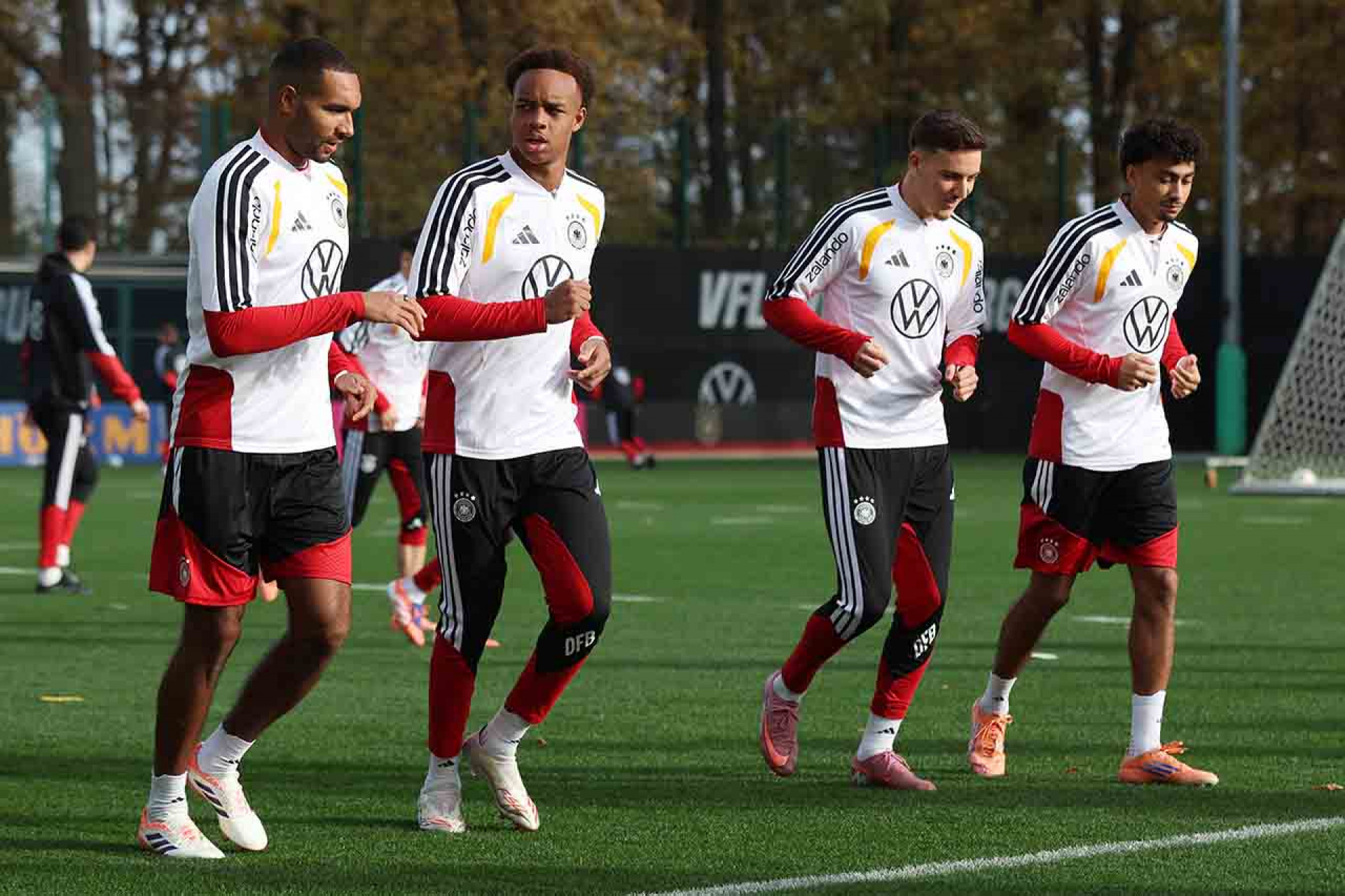 WOLFSBURG, GERMANY - NOVEMBER 13: Jonathan Tah, Assan Ouedraogo, Said El Mala and Nathaniel Brown run during a training session of the German national team on November 13, 2025 in Wolfsburg, Germany. (Photo by Ronny Hartmann/Getty Images)