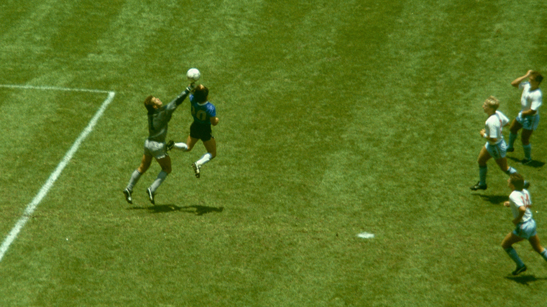MEXICO CITY, MEXICO - JUNE 22: Argentina player Diego Maradona outjumps England goalkeeper Peter Shilton to score with his 'Hand of God' goal as England defenders Kenny Sansom (top) Gary Stevens (c) and Terry Fenwick look on during the 1986 FIFA World Cup Quarter Final at the Azteca Stadium on June 22, 1986 in Mexico City, Mexico.  (Photo by Allsport/Getty Images)