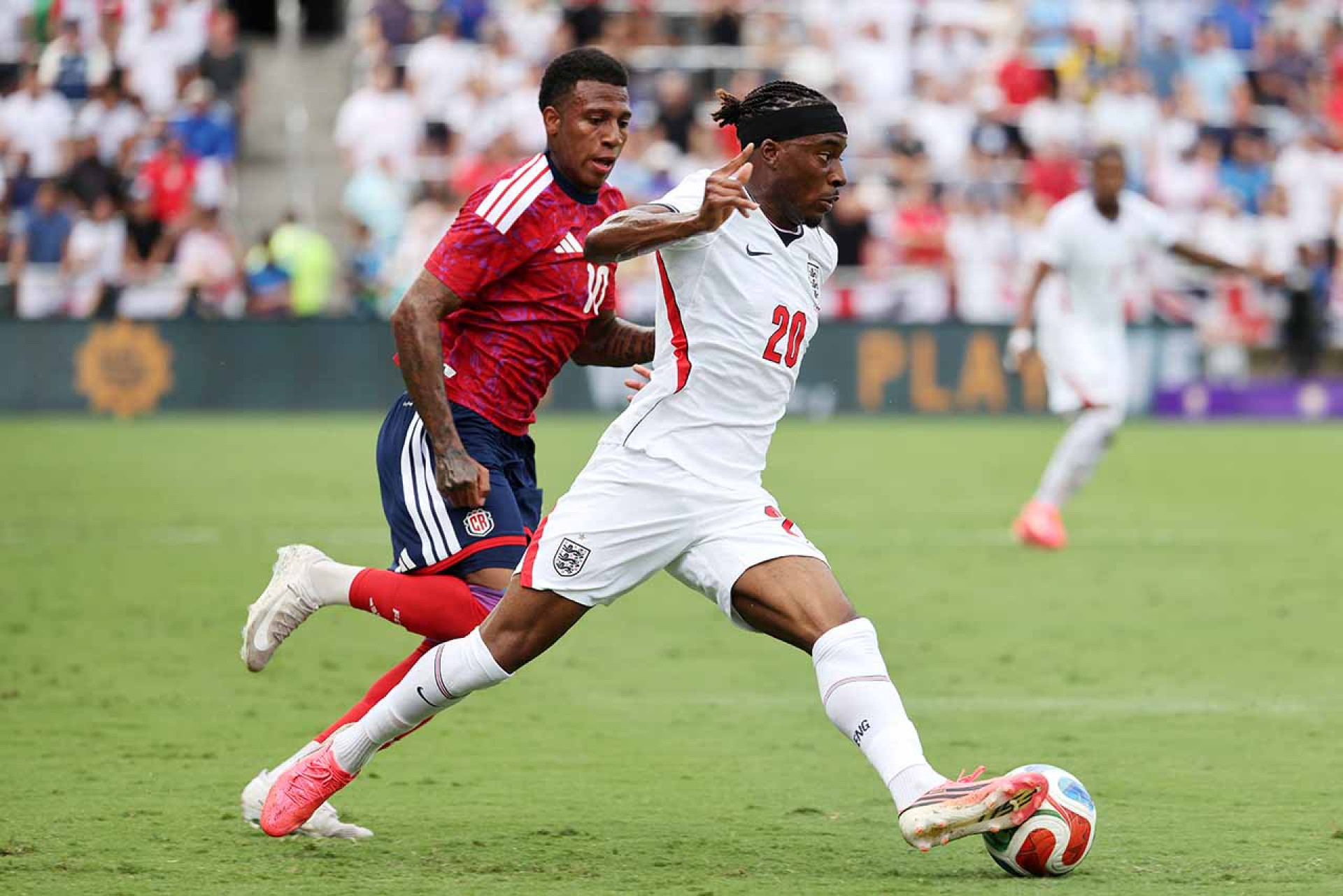 ORLANDO, FLORIDA - JUNE 10: Noni Madueke #20 of England runs with the ball whilst under pressure from Josimar Alcocer of Costa Rica during the International Friendly match between England and Costa Rica at Inter&Co Stadium on June 10, 2026 in Orlando, Florida. (Photo by Alex Menendez/Getty Images)