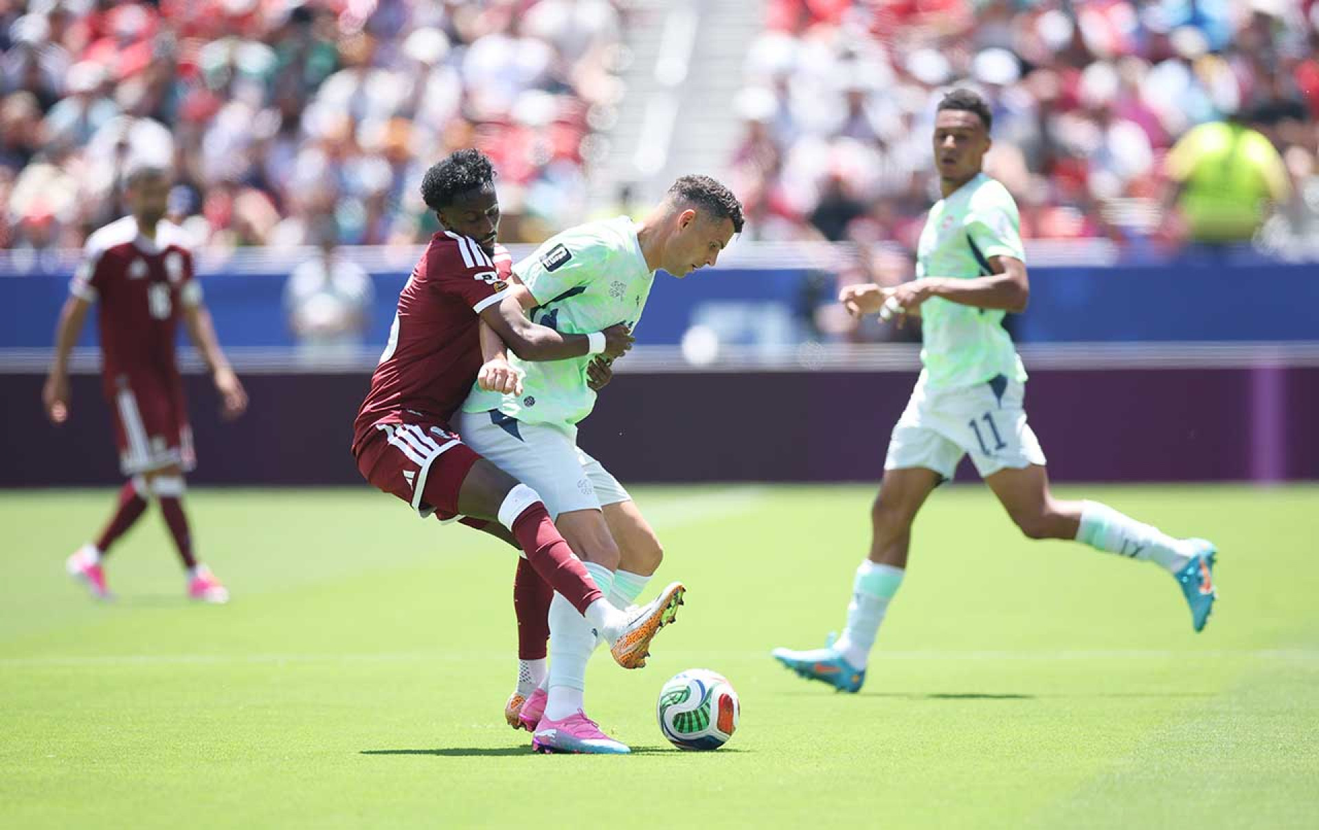SANTA CLARA, CALIFORNIA - JUNE 13: Granit Xhaka #10 of Switzerland is challenged by Yusuf Abdurisag #15 of Qatar during the FIFA World Cup 2026 Group B match between Qatar and Switzerland at San Francisco Bay Area Stadium on June 13, 2026 in Santa Clara, California. (Photo by Alex Grimm/Getty Images)