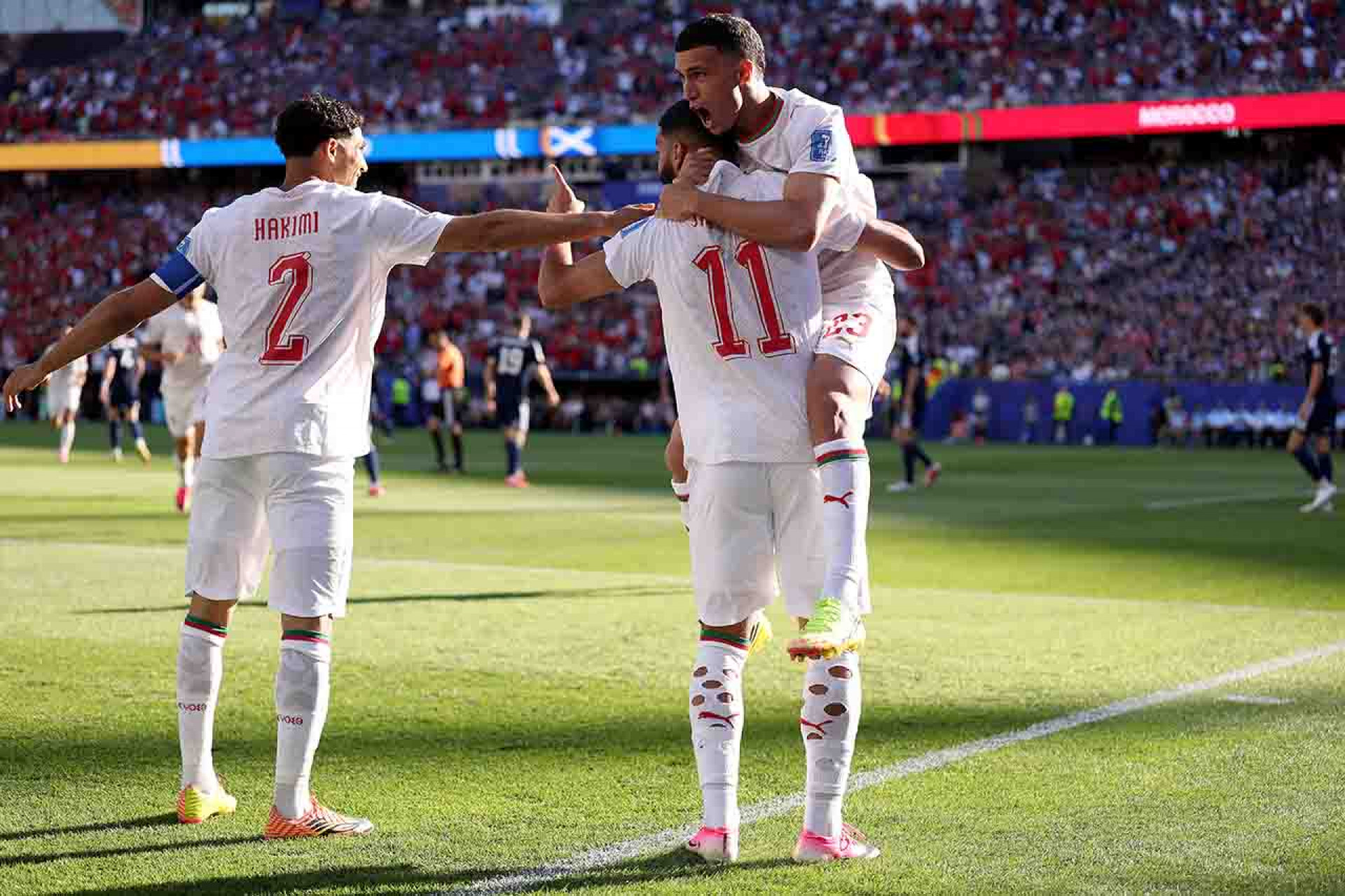 FOXBOROUGH, MASSACHUSETTS - JUNE 19: Ismael Saibari  #11 of Morocco celebrates with teammates Achraf Hakimi #2 and Bilal El Khannouss #23 after scoring his team's first goal during the FIFA World Cup 2026 Group C match between Scotland and Morocco at Boston Stadium on June 19, 2026 in Foxborough, Massachusetts. (Photo by Justin Setterfield/Getty Images)
