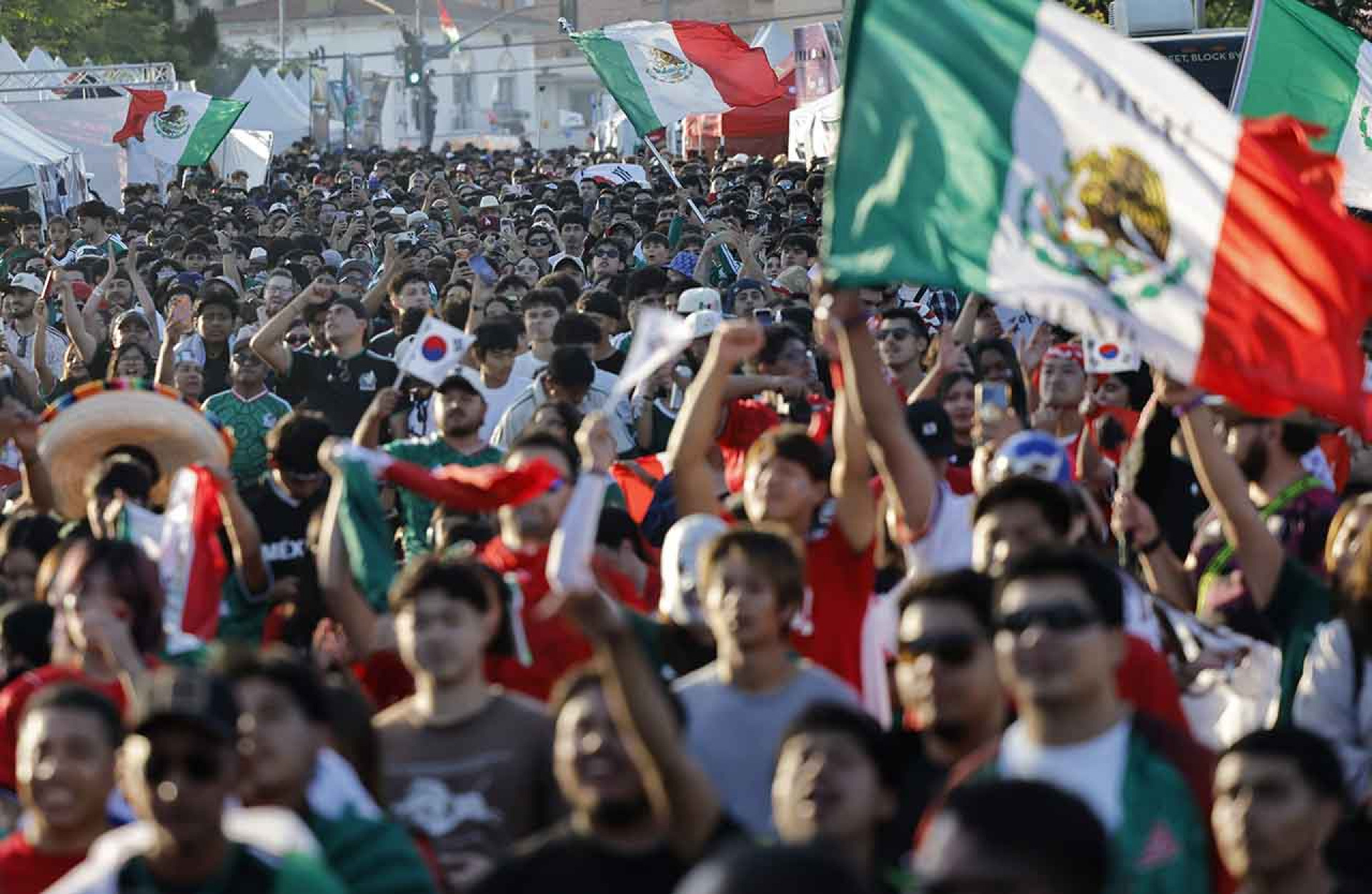 LOS ANGELES, CALIFORNIA - JUNE 18: South Korea and Mexico fans gather during a watch party in Koreatown, home to large Korean and Mexican communities, during the World Cup match between the two countries on June 18, 2026 in Los Angeles, California. Mexico became the first team to advance to the knockout stage after defeating South Korea 1-0 and Los Angeles is hosting eight matches during the 2026 FIFA World Cup. (Photo by Mario Tama/Getty Images)