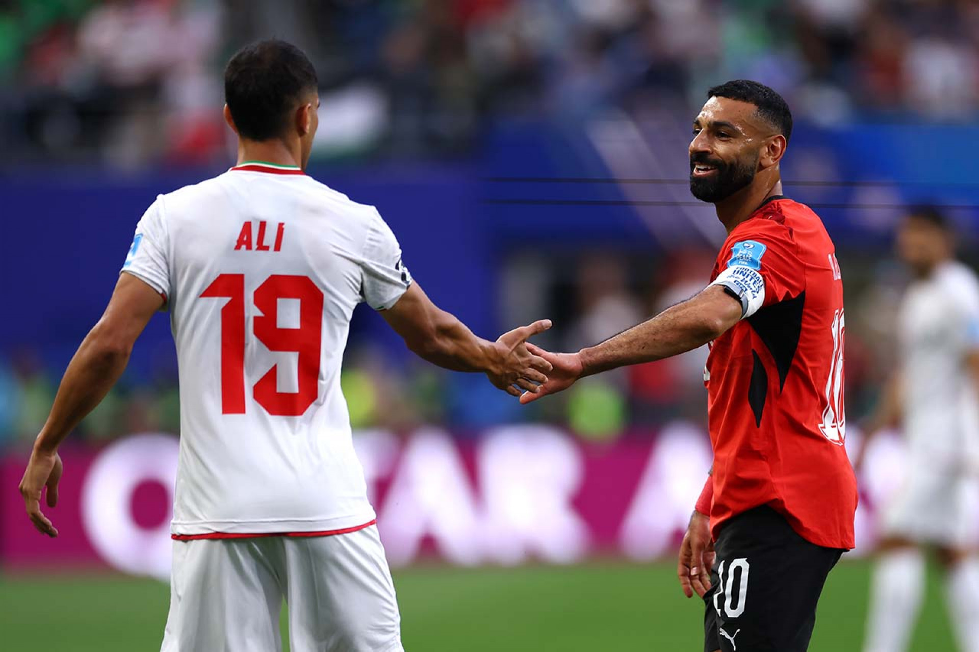 SEATTLE, WASHINGTON - JUNE 26: Ali Nemati #19 of IR Iran high fives Mohamed Salah #10 of Egypt during the FIFA World Cup 2026 Group G match between Egypt and IR Iran at Seattle Stadium on June 26, 2026 in Seattle, Washington. (Photo by Dean Mouhtaropoulos/Getty Images)