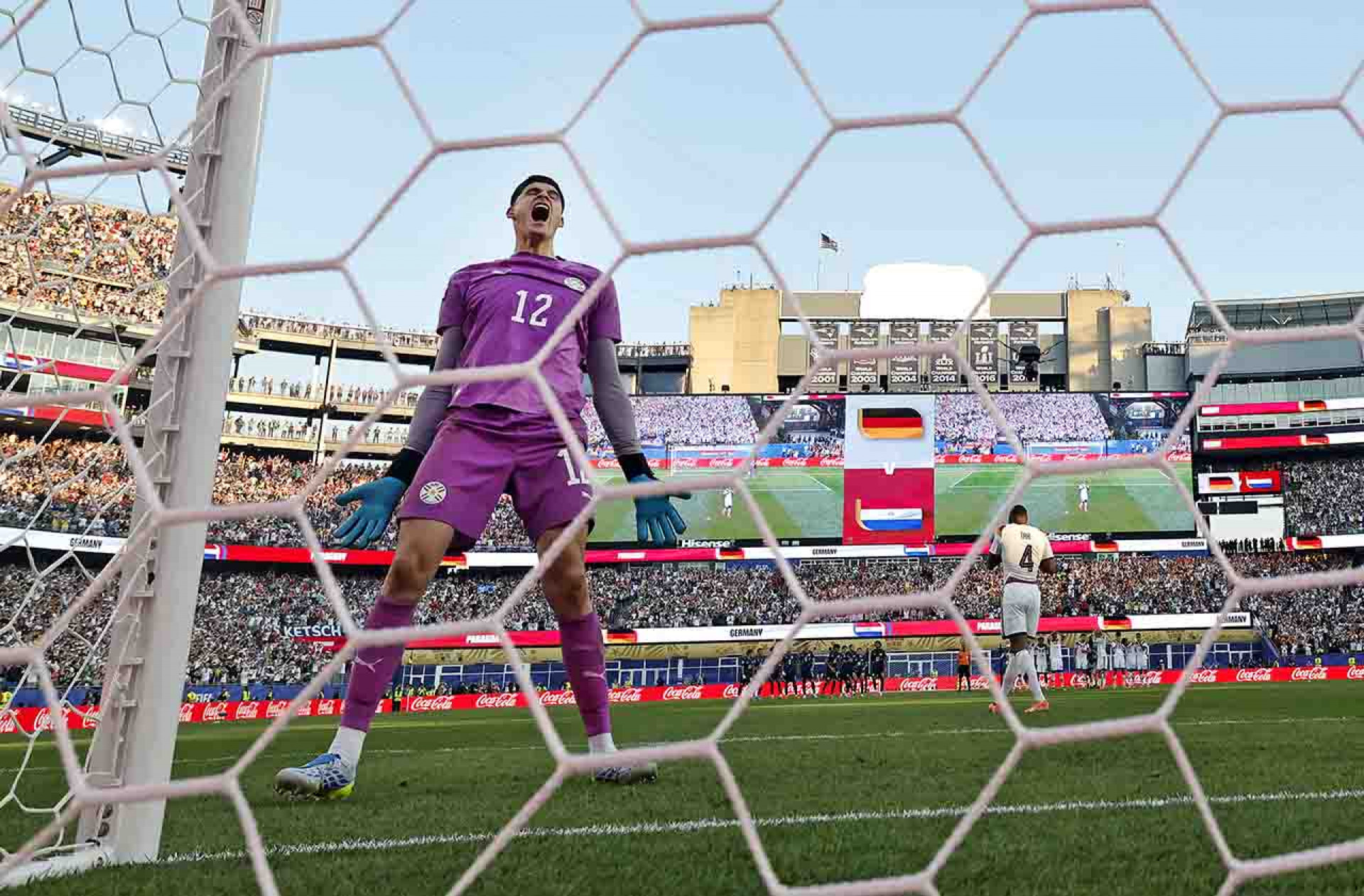 FOXBOROUGH, MASSACHUSETTS - JUNE 29: (EDITOR'S NOTE: Image was captured using a remote camera from behind the goal.) Orlando Gill #12 of Paraguay celebrates after saving the sixth penalty by Jonathan Tah #4 of Germany in a penalty shootout during the FIFA World Cup 2026 Round Of 32 match between Germany and Paraguay at Boston Stadium on June 29, 2026 in Foxborough, Massachusetts. (Photo by Michael Reaves/Getty Images)