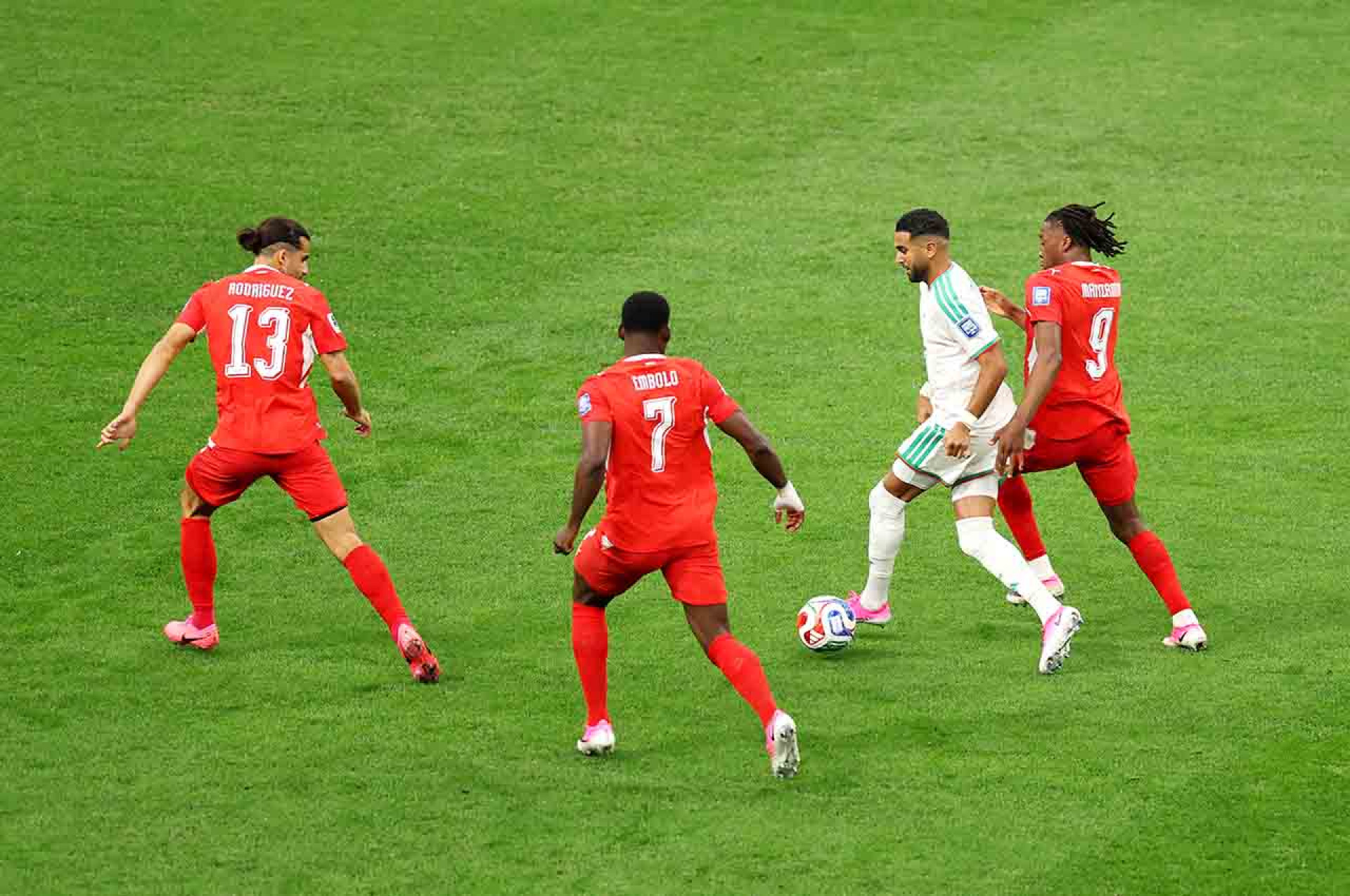 VANCOUVER, BRITISH COLUMBIA - JULY 02: Riyad Mahrez #7 of Algeria controls the ball against Ricardo Rodriguez #13, Breel Embolo #7 and Johan Manzambi #9 of Switzerland during the FIFA World Cup 2026 Round of 32 match between Switzerland and Algeria at BC Place Vancouver on July 02, 2026 in Vancouver, British Columbia. (Photo by Fran Santiago/Getty Images)