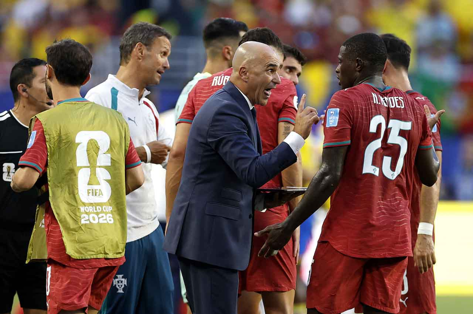 MIAMI GARDENS, FLORIDA - JUNE 27: Roberto Martinez, Head Coach of Portugal, speaks to Nuno Mendes #25 at the hydration break during the FIFA World Cup 2026 Group K match between Colombia and Portugal at Miami Stadium on June 27, 2026 in Miami Gardens, Florida. (Photo by Michael Reaves/Getty Images)