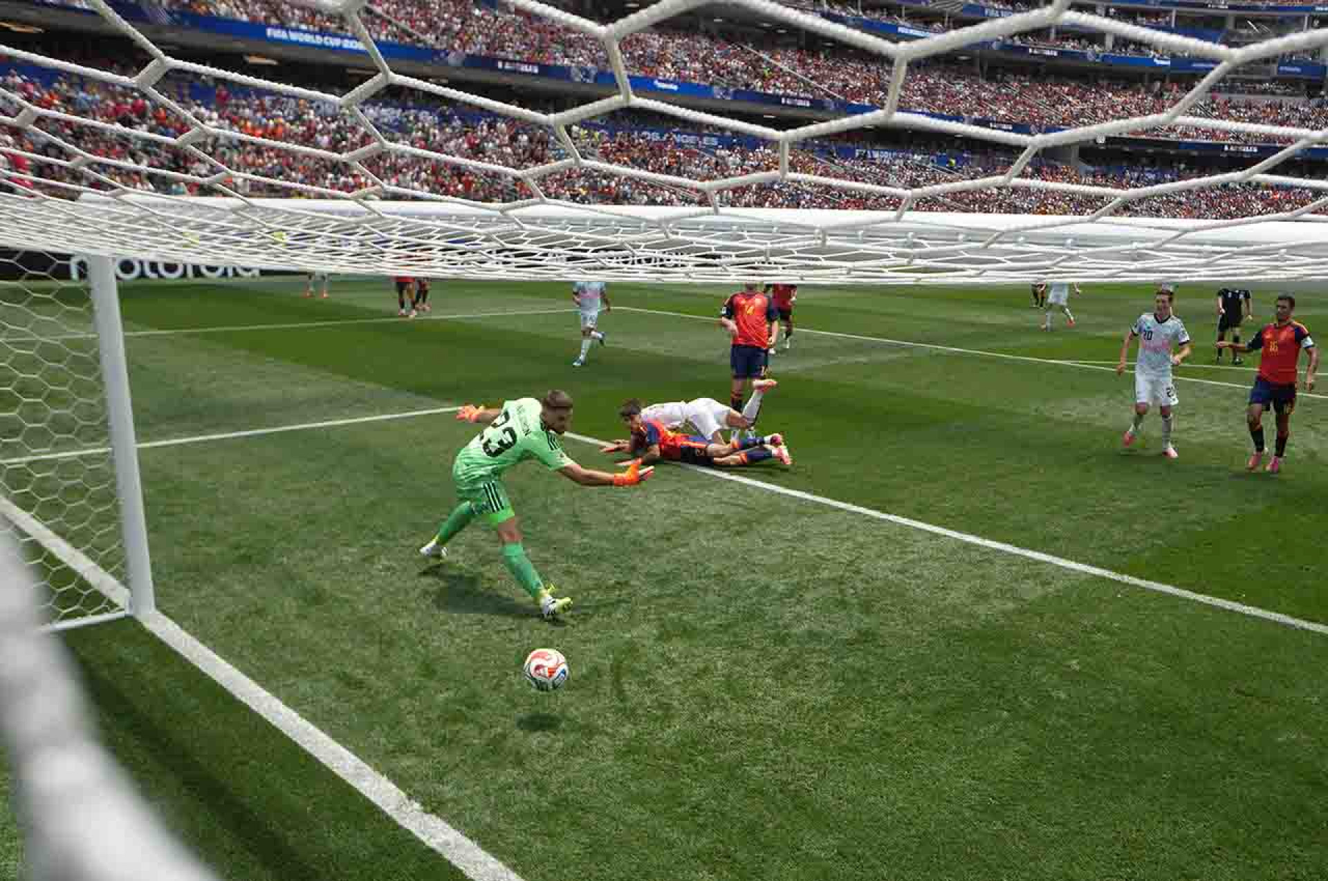 INGLEWOOD, CALIFORNIA - JULY 10: (EDITORS NOTE: Image was captured using a remote camera positioned in the net.) Charles De Ketelaere #17 of Belgium scores his team's first goal past Unai Simon #23 of Spain during the FIFA World Cup 2026 Quarter Final match between Spain and Belgium at Los Angeles Stadium on July 10, 2026 in Inglewood, California. (Photo by David Ramos/Getty Images)