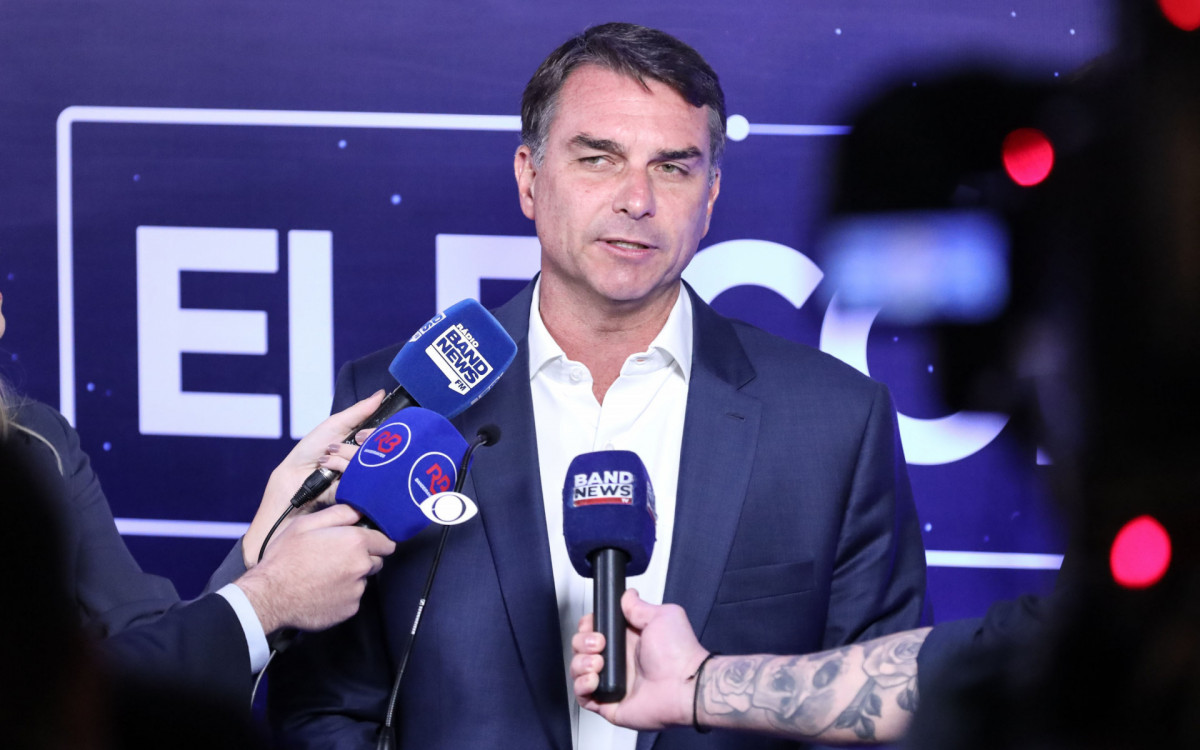 Candidato a Presidência da República, Flávio Bolsonaro (PL) conversa com os jornalistas antes do debate presidencial promovido pela TV Bandeirantes, na sede da emissora, região sul de São Paulo, neste domingo (18).
